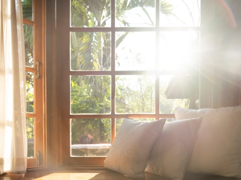 closed windows with sun coming through on a summer day.