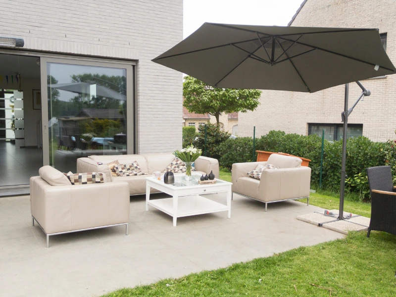 home outdoor area shaded by an umbrella stand.